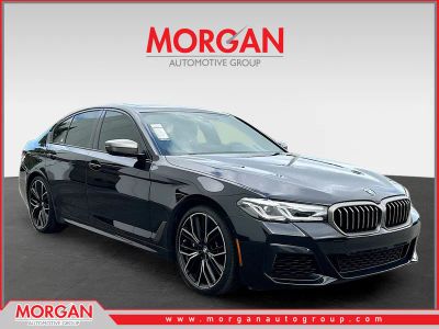 2023 BMW 5 Series M550i xDrive in Black Sapphire Metallic — front three-quarter view