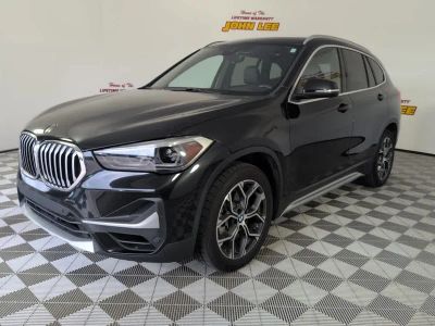 2021 BMW X1 sDrive28i in Black Sapphire Metallic — front three-quarter view