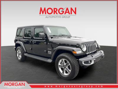 2022 Jeep Wrangler Unlimited Sahara in Black — front three-quarter view
