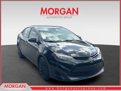 2018 Toyota Corolla LE in Black Sand Pearl — front three-quarter view