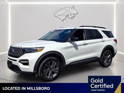 2023 Ford Explorer XLT in Star White Metallic Tri-Coat — front three-quarter view