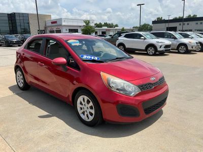 2013 Kia Rio LX in Signal Red — front three-quarter view