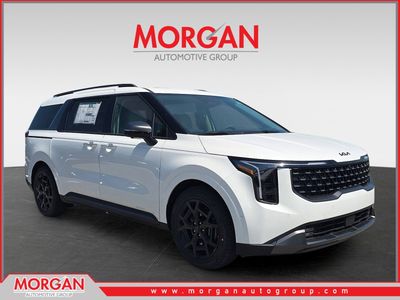 2026 Kia Carnival SX Prestige in Snow White Pearl — front three-quarter view