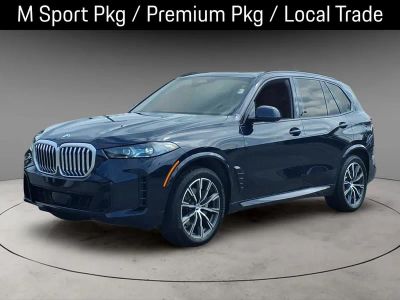 2024 BMW X5 xDrive40i in Carbon Black Metallic — front three-quarter view