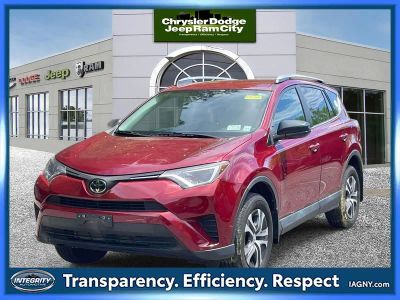 2018 Toyota RAV4 LE in Red — front three-quarter view
