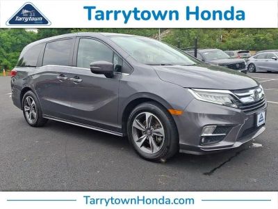 2019 Honda Odyssey Touring in Modern Steel Metallic — front three-quarter view