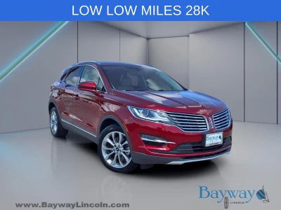 2018 Lincoln MKC Select in Ruby Red Metallic — front three-quarter view