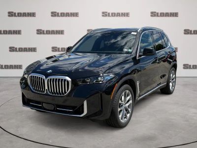 2026 BMW X5 xDrive40i in Black Sapphire Metallic — front three-quarter view