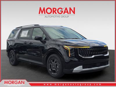 2026 Kia Carnival Hybrid EX in Aurora Black Pearl — front three-quarter view
