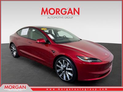 2024 Tesla Model 3 Long Range in Ultra Red — front three-quarter view