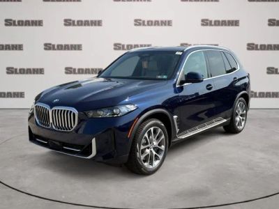 2026 BMW X5 xDrive50e in Tanzanite Blue II Metallic — front three-quarter view