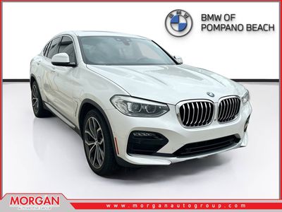 2021 BMW X4 xDrive30i in Mineral White Metallic — front three-quarter view