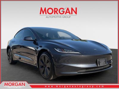 2025 Tesla Model 3 Long Range in Stealth Grey — front three-quarter view