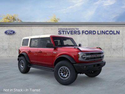 2026 Ford Bronco Outer Banks in Ruby Red Metallic Tinted Clearcoat — front three-quarter view
