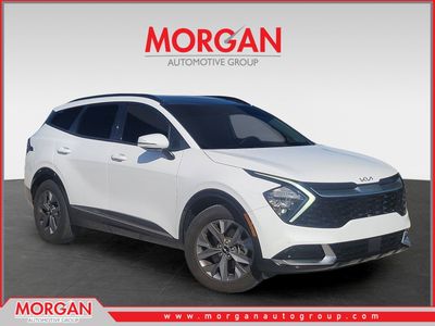 2023 Kia Sportage SX in Glacial White Pearl — front three-quarter view