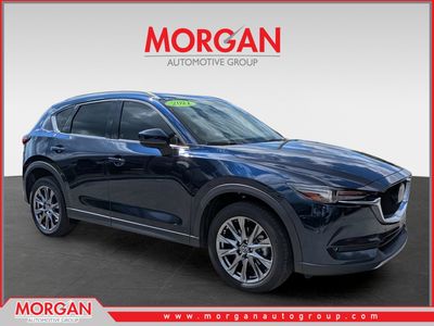 2021 Mazda CX-5 Signature in Deep Crystal Blue Mica — front three-quarter view