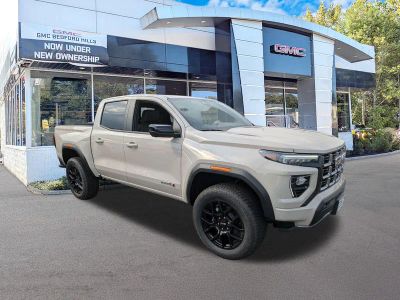 2026 GMC Canyon 4WD AT4 in Coastal Dune — front three-quarter view