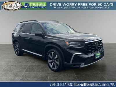 2023 Honda Pilot Touring in Black — front three-quarter view