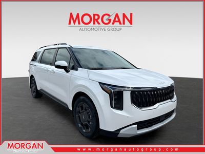 2026 Kia Carnival Hybrid EX in Snow White Pearl — front three-quarter view