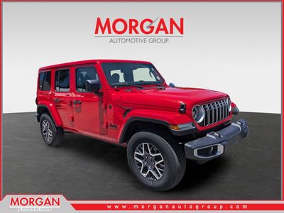 2025 Jeep Wrangler Sahara in Firecracker Red Clearcoat — front three-quarter view