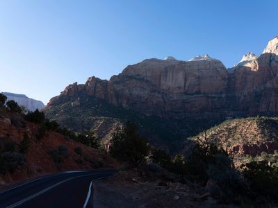 a road with a mountain in the background