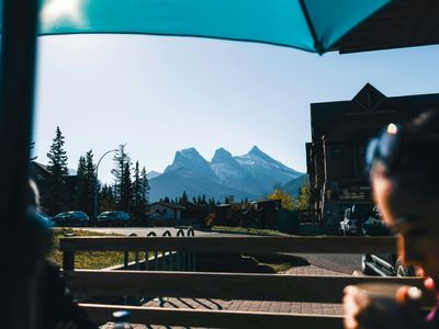 Mountains seen from a cafe patio with person in foreground