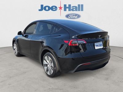 2023 Tesla Model Y — rear three-quarter view