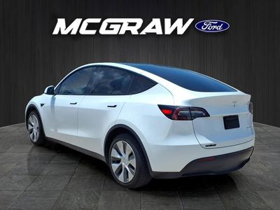 2023 Tesla Model Y — rear three-quarter view