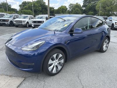 2024 Tesla Model Y — rear three-quarter view