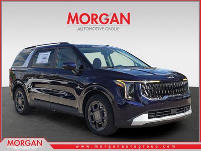 2026 Kia Carnival Hybrid EX in Deep Chroma Blue — front three-quarter view