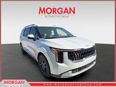 2026 Kia Carnival Hybrid EX in Snow White Pearl — front three-quarter view