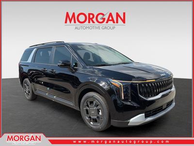 2026 Kia Carnival Hybrid EX in Aurora Black Pearl — front three-quarter view