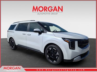 2026 Kia Carnival EX in Snow White Pearl — front three-quarter view