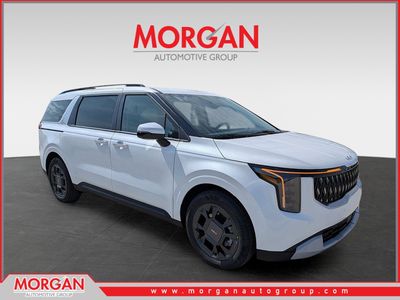 2026 Kia Carnival Hybrid EX in Snow White Pearl — front three-quarter view