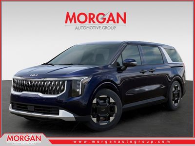2026 Kia Carnival EX in Deep Chroma Blue — front three-quarter view