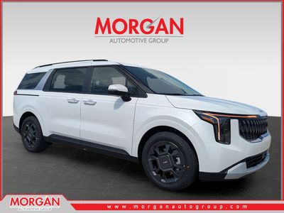2026 Kia Carnival Hybrid EX in Snow White Pearl — front three-quarter view