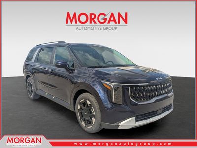 2026 Kia Carnival EX in Deep Chroma Blue — front three-quarter view