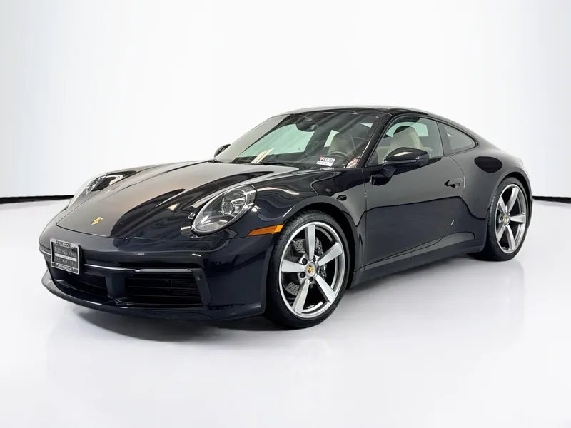 2024 Porsche 911 Carrera in Jet Black Metallic — front three-quarter view
