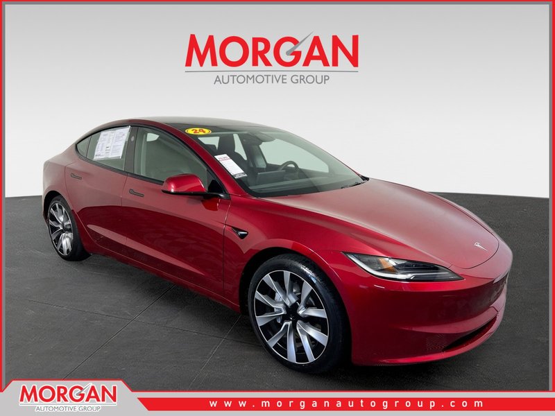 2024 Tesla Model 3 Long Range in Ultra Red — front three-quarter view