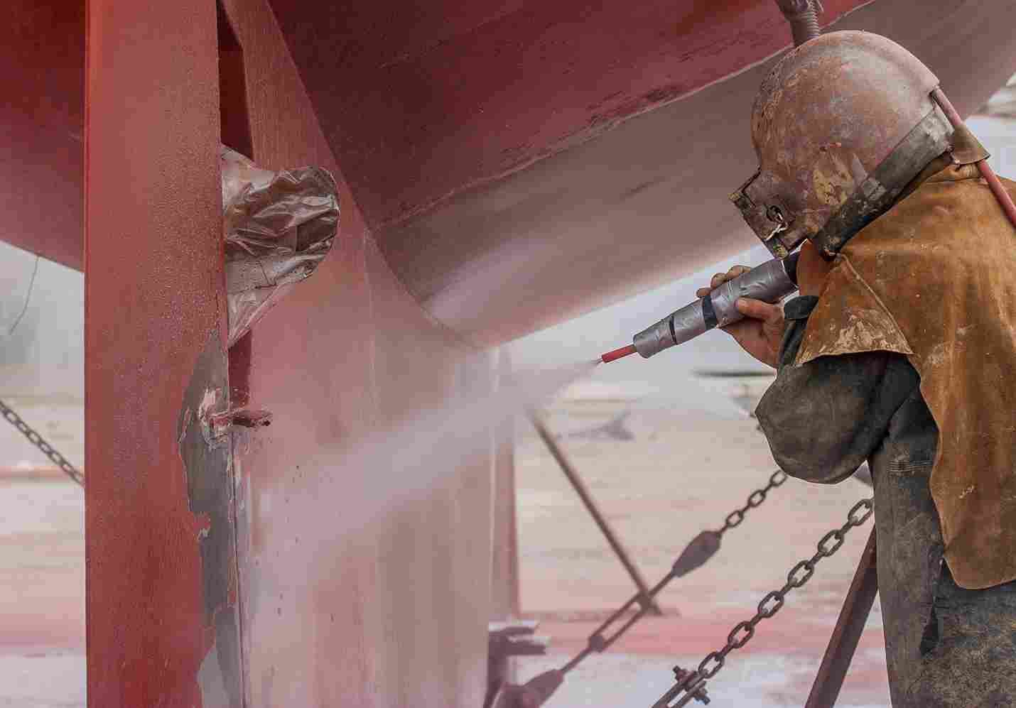 worker-sandblasting-the-corroded-hull-of-a-boat