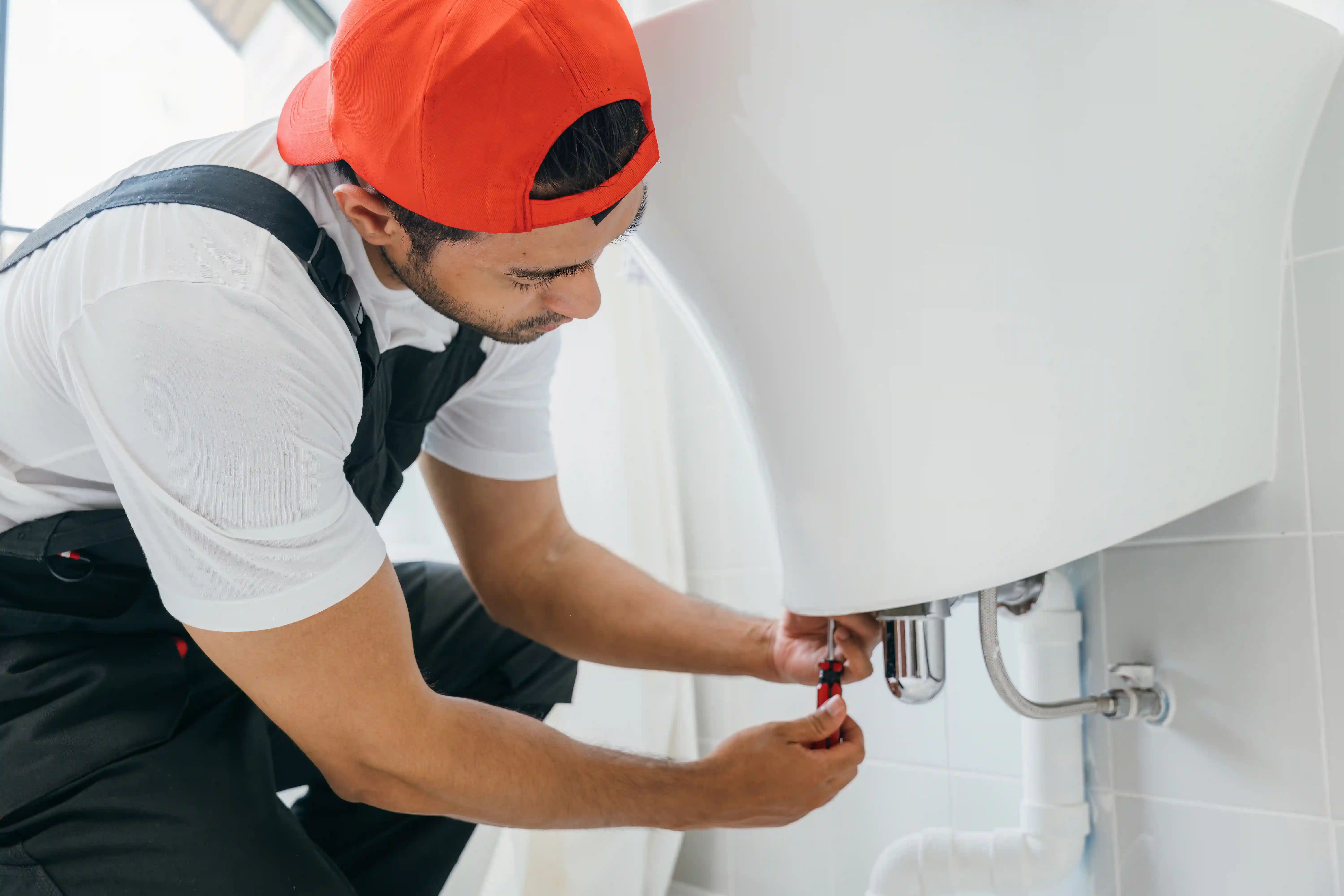 with-a-wrench-in-hand-a-technician-fixes-a-waterleakage