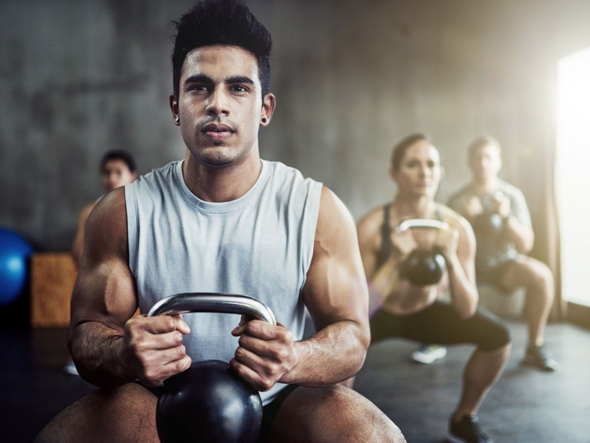 man doing weighted squats 