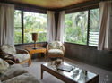 Aunty Lydia's Ohana - A comfy living room with garden & mountain views just a minute's walk to the beach.