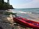 Lake Michigan Sunset Cottage - Kayaks rest on 200 feet of private beach in front of the cottage