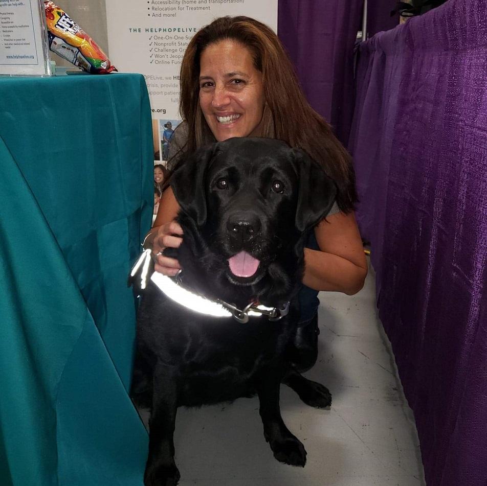 Help Hope Live team member hugs dog