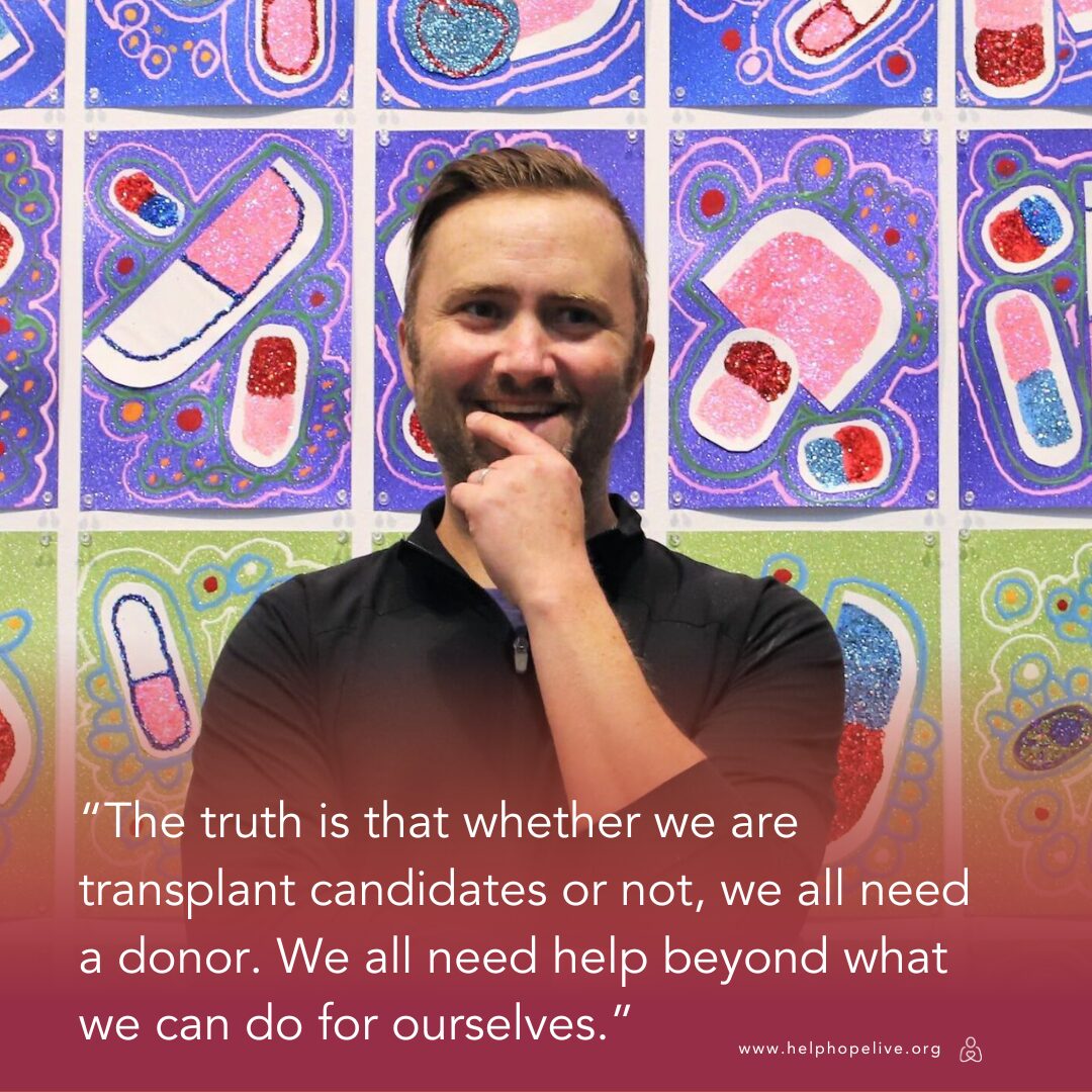 Transplant recipient and artist Dylan Mortimer has light skin, short brown hair, and a short brown beard. He is raising his left hand thoughtfully to his chin. Behind him is tiled artwork by him depicting pills and abstract antibody-like shapes in pink, white, red, blue, and green with glitter. Text reads 