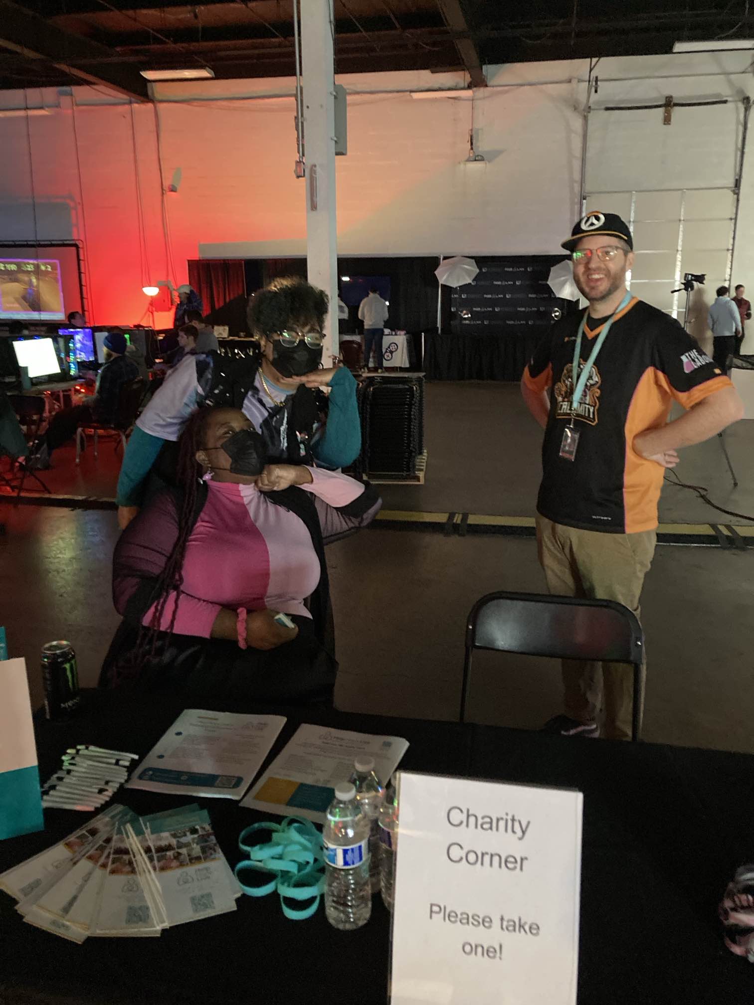 Vanessa Nichols of Help Hope Live with her partner is meeting Chris Carlin or ClemClementine at the RGB LAN 6 charity gaming event. Vanessa is seated at a