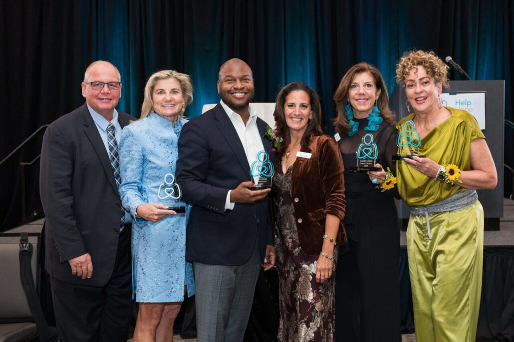 Marilyn Clark and Gerhard Schmit, Michael Newmuis, Kelly L Green, Stephanie McAlaine, and Lisa Thomas Laury formally dressed at the 2024 Live It Up! gala supporting Help Hope Live.