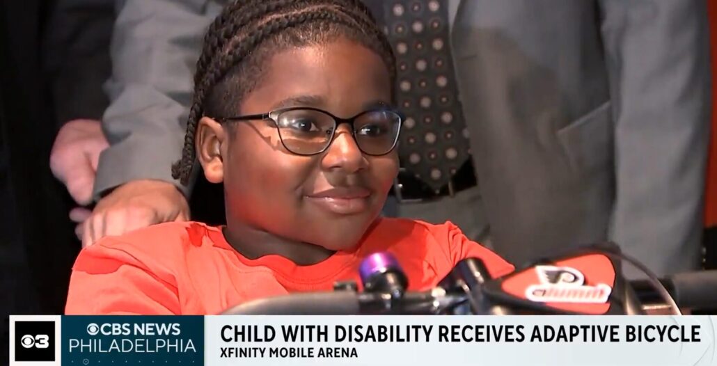 CBS coverage of Raymeer Bacon-El receiving an adaptive bike in October 2025.