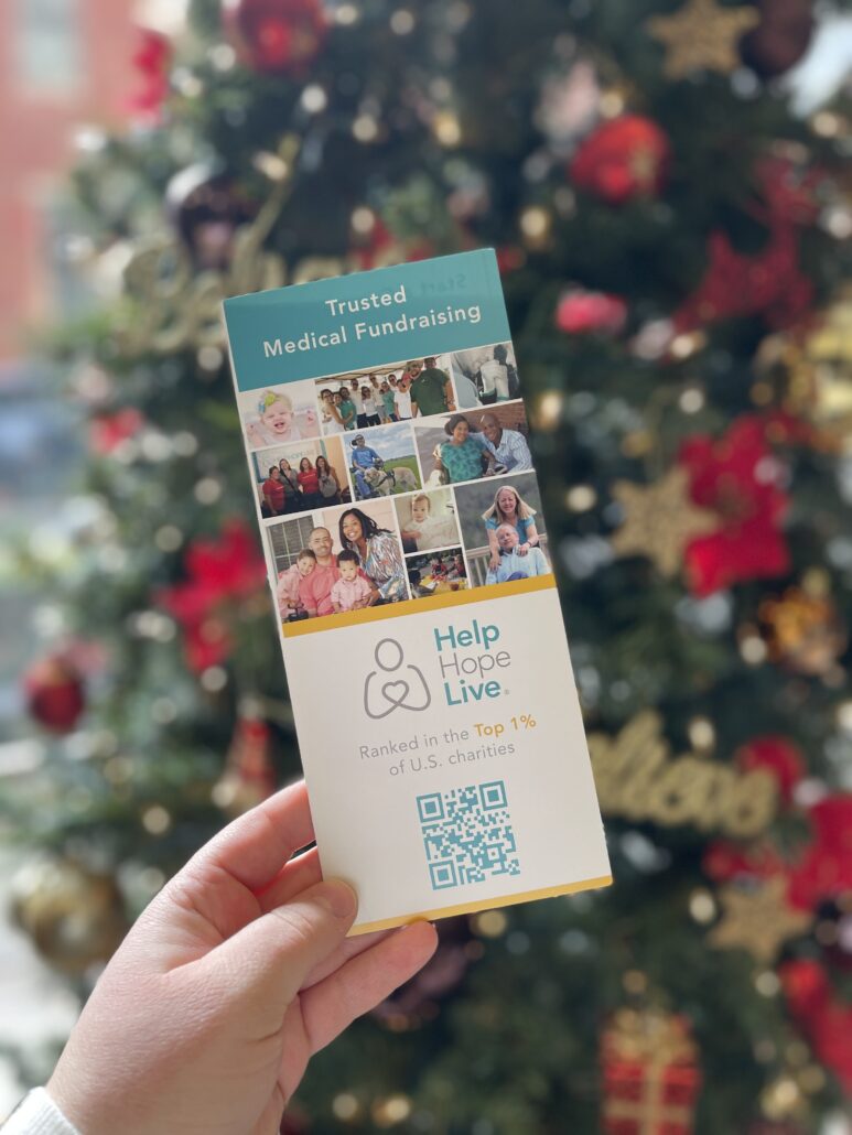 Help Hope Live brochure in front of a decorated Christmas tree in December 2025 at Magee.